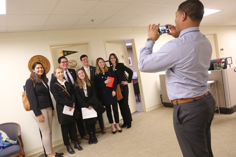 Miles Gordon takes a photo of W&M students who stopped by the office of W&M alumnus Del. Jeffrey Bourne '99, J.D. '07. (Photo by Stephen Salpukas)