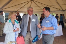 VIMS Professor Rob Latour (right) discusses use of the RV Virginia by his multispecies research group with VIMS Foundation Board member David Nelson Meeker (center) and guest in the science tent on the Yorktown waterfront prior to the christening. (Photo by C. Katella/VIMS)