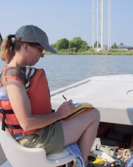 Tami Rudnicky of CCRM uses a hand-held GPS unit to tag GPS coordinates with the shoreline conditions she observes along the shoreline in Virginia. (CCRM/VIMS photo)