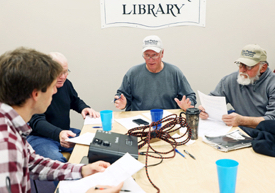 Local waterman J.C. Hudgins (C) talks with VIMS graduate student Jim DelBene (L) during a focus group with local watermen. (Photo by A. Devlin, VASG)