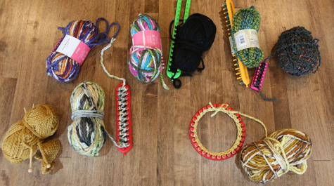An assortment of yarn, needles and looms