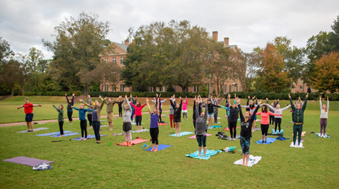 People engage in yoga in the Sunken Garden