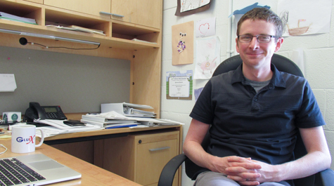 Physicist Justin Stevens is pictured sitting in his office at Small Hall at William & Mary
