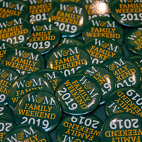 Green buttons with W&M Family Weekend 2019 printed on them