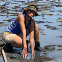 Chanté Lively examines a muddy tidal flat