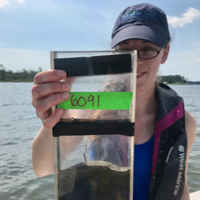 Danielle Tarpley holds a sediment core