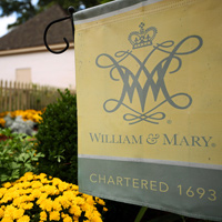 A decorative W&M garden flag outside the president's house