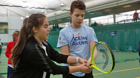 A volunteer helps one of the participants. (Photo by Stephen Salpukas)