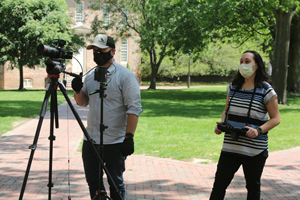 Crawford (right) and Jake Loyd film a portion of the 2020 Commencement ceremony on campus in May. (Photo by Stephen Salpukas)