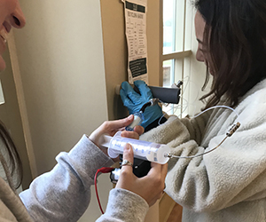 W&M students Hannah Przelomski and Gloria Ge test the Indoor Surface Extractor (Courtesy photo)