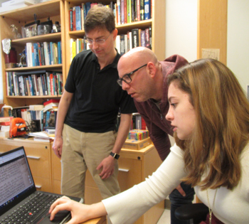 Collaborators (from left) Joshua Erlich, Nick Popper and Caitlin Dolt examine annotations on a digitized page from the Principia. (Photo by Joseph McClain)