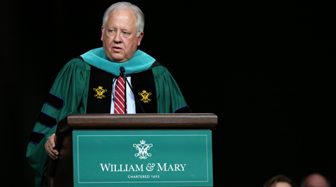 Thomas Shannon dressed in academic regalia and speaking at a podium