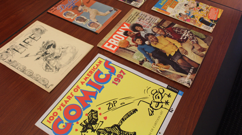 Comic books and other magazines sit on stop of a table