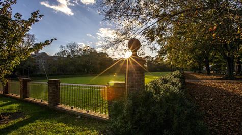 Rays of sunlight are seen behind a post at an end of the Sunken Garden