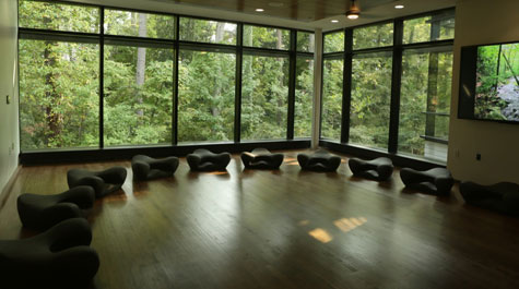 Interior of McLeod Tyler Wellness Center with low seats on dark hardwood floor