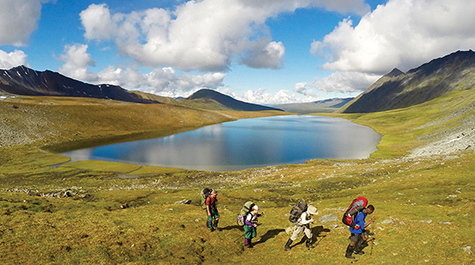 A group of students crosses Alaskan terrain