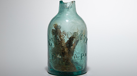 Glass jug filled with nails that is believed to be a rare ritual item known as a “witch bottle."