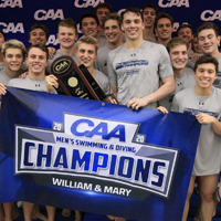 Swimmers hold up a blue CAA champs sign