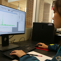 Student combs through data on a computer