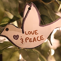 Paper dove with words 'peace and love'