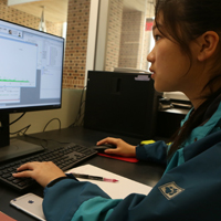 Chemistry student Hongmin Yu analyzes data in the lab