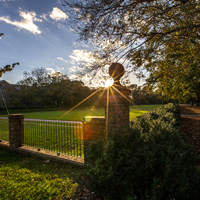 Rays of sunlight are seen behind a post at an end of the Sunken Garden