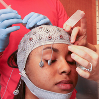 A student participates in an electroencephalogram (EEG) study