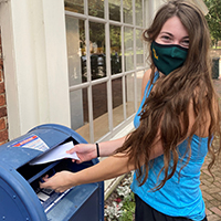 Julia Brown places her ballot in a mailbox