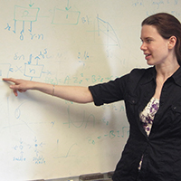 Leah Shaw demonstrates calculations on a whiteboard