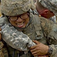 Army medic carries a simulated casualty during a combat scenario