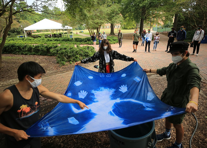 Pandemic conditions brought new challenges as well as discoveries for the students participating in the COLL 100 photography class, taught by Lecturer of Art Eliot Dudik. The class worked on cyanotypes, which is a type of outdoor photographic process. (Photo by Stephen Salpukas)