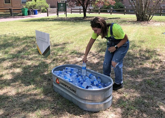 Georgia Carpenter '24 grabs some cold water from one of the university's water stations. (Photo by Adrienne Berard)
