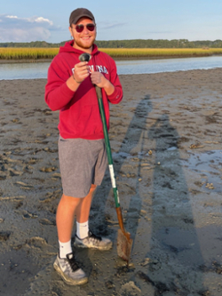 M.A. student Will Shoup explores a tidal mudflat during the annual new-student field trip to Virginia’s Eastern Shore and VIMS’ Eastern Shore Laboratory. (Photo by J. Griffin/VIMS)