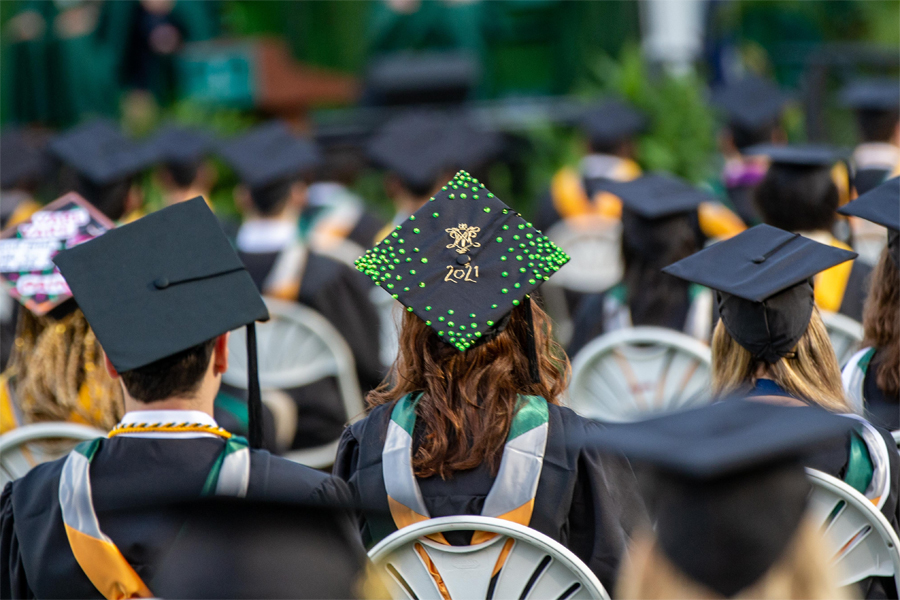 Mortarboard with confetti, the William & Mary cypher and Class of 2021
