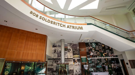 Bob Solderitch Atrium with gold letters above photo montage on wall