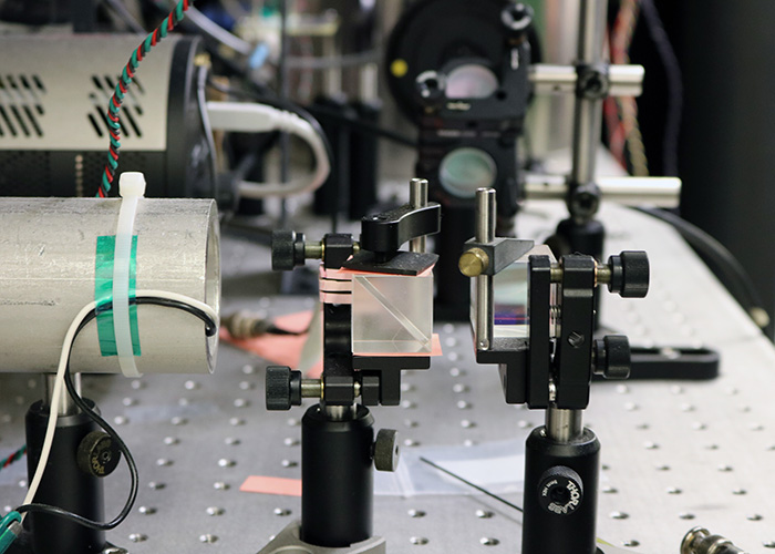 To measure magnetic field, the team fires infrared lasers, set to specific frequencies, through a series of lenses. (Photo by Adrienne Berard)