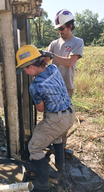 Grace Weeks ’23 helps VIMS professor Chris Hein extract a sediment core during geologic research on the barrier islands of Virginia's Eastern Shore.