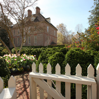 a view of the president's house from its garden in spring with tulips blooming