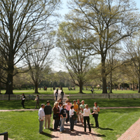 A guide leads a tour group on campus
