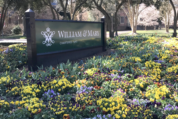 William and Mary campus sign surrounded by spring flowers.