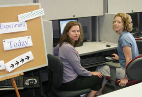 Lisa Anderson (l) and Jennifer Mellor routinely conduct experimental games in a lab in Morton Hall. Photo by David Williard.