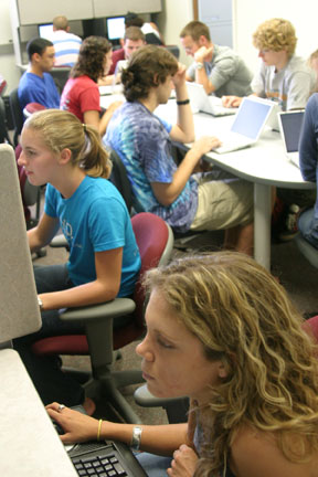 Students play games that contribute to research in the Experimental Economics Laboratory. Photo by David Williard.