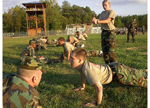 Photo: William and Mary ROTC Cadet Stephen Draheim (front doing push-ups) and Cadet Jennifer Purser (standing) participate in last year's Ranger Challenge Competition. By Maj. Don Caughey.