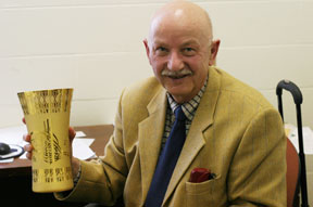 Bechtold holds one of the numerous awards he has received for foreign service. By David Williard.
