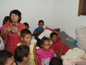 Fujiyama (l) is surrounded by children at the Capprome orphanage. Courtesy of SHH.
