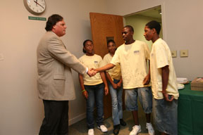 Nichol (l) greets students who were visiting the College with the Horizons program. By Stephen Salpukas.