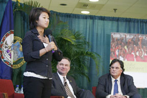 Fujiyama (standing) makes remarks while Gov. Kaine and Nichol applaud. By Stephen Salpukas.