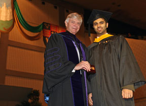 Rastogi receives the Lord Botetourt Medal from Interim President Reveley. By Stephen Salpukas.