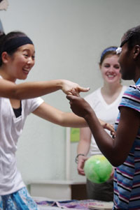 A W&M student dances with a child at Grace Children's Hospital during the recent W&M Haiti Compact alternative break.