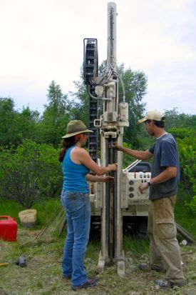 Hein and colleague Christine Brandon take a sediment core to study past changes in the coastal zone.